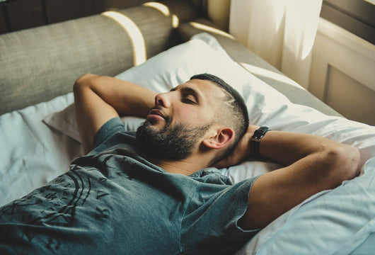Man resting in bed, winding down for the night